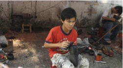 Kid_making_shoes_in_the_street