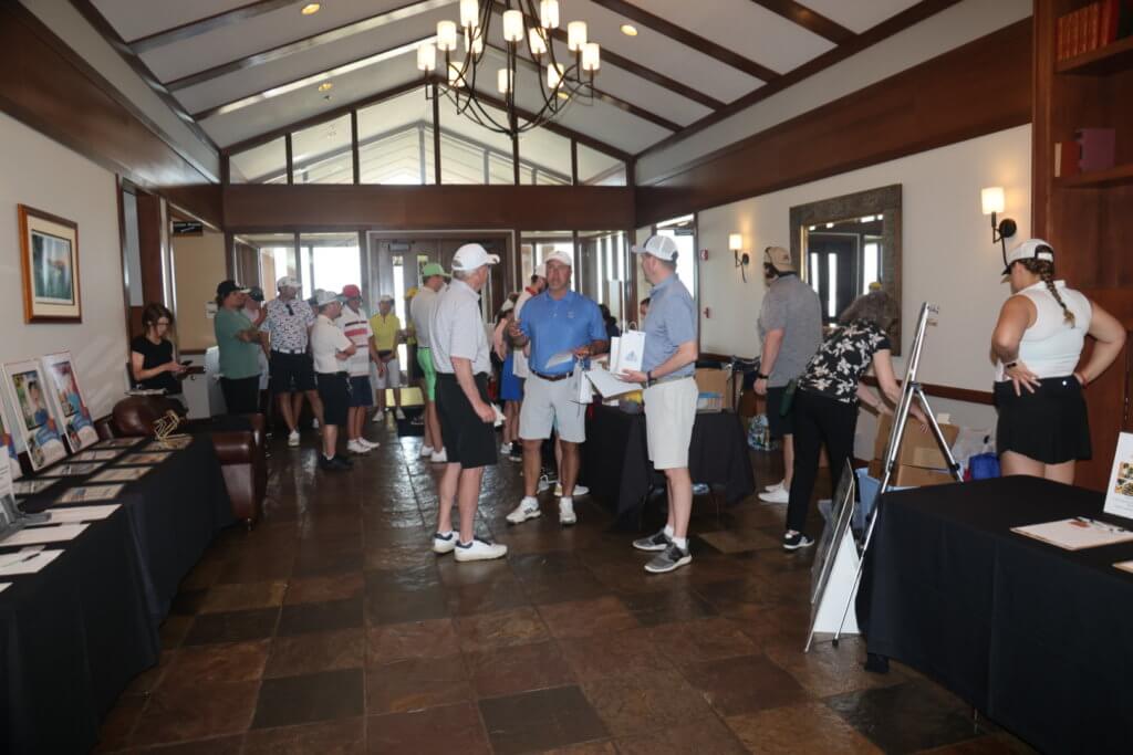 Golfers chat in The Wilds Golf Course Clubhouse before teeing off at the 4th Annual Bridges to Learning Golf Tournament in Prior Lake Minnesota. Raising funds to educate and care for poor children in Vietnam.