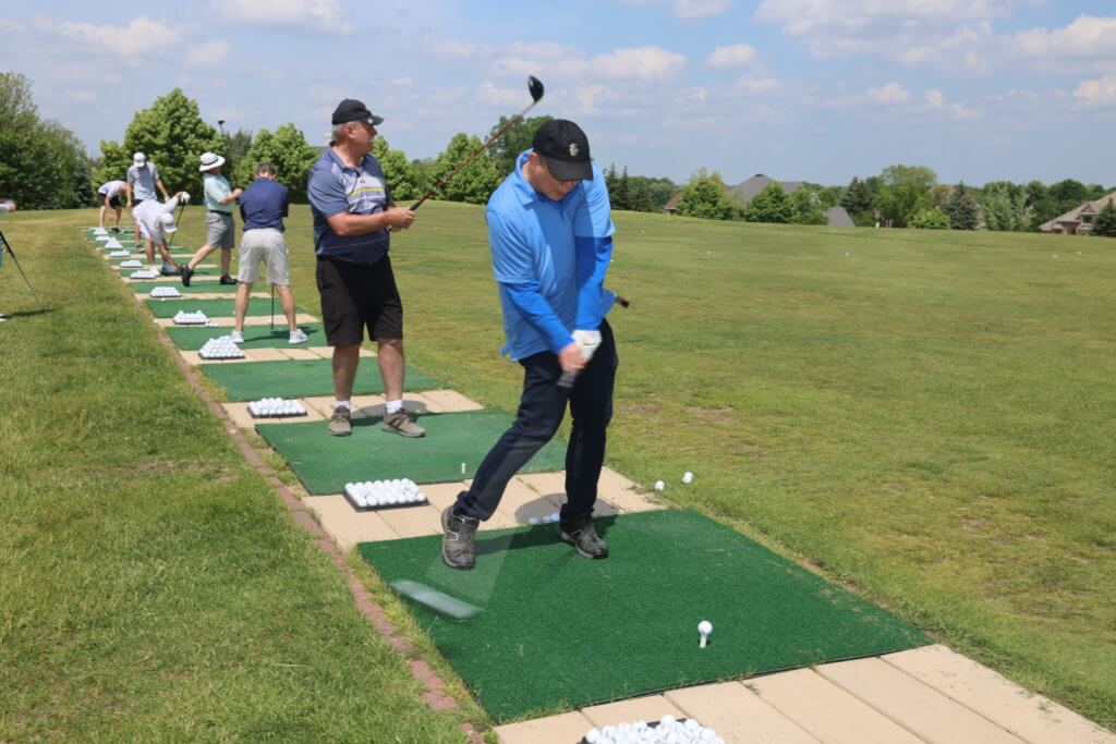 Golfer warms up at the driving range at the 4th Annual Bridges to Learning Golf Tournament at The Wilds Golf Club, Prior Lake Minnesota. Raising funds to educate and care for poor children in Vietnam.