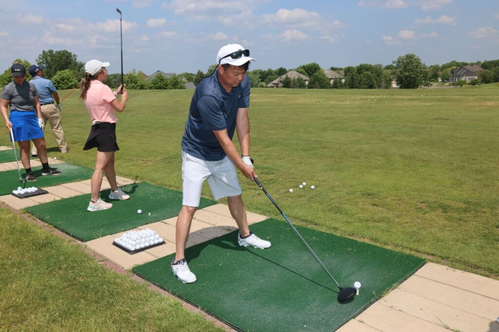 Golfer warming up at the driving range at the 4th Annual Bridges to Learning Golf Tournament at The Wilds Golf Club, Prior Lake Minnesota. Raising funds to educate and care for poor children in Vietnam.