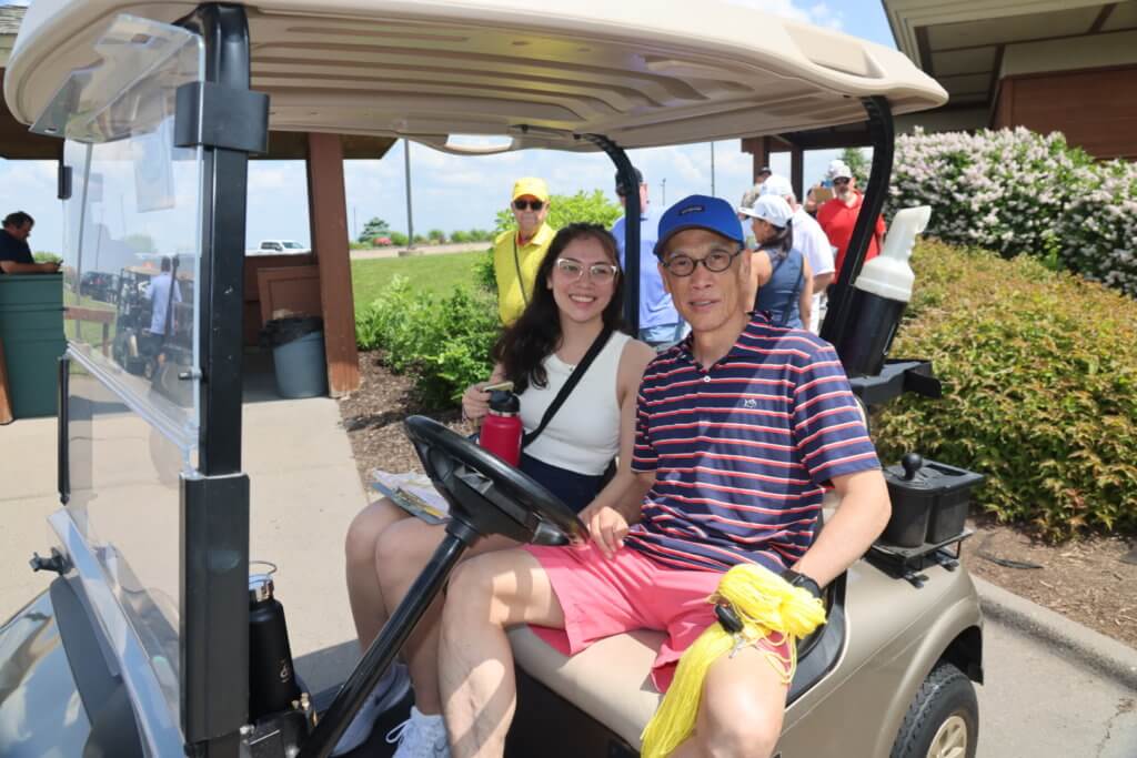 Volunteers sit in cart before heading out to lead games at the 4th Annual Bridges to Learning Golf Tournament at The Wilds Golf Club, Prior Lake Minnesota. Raising funds to educate and care for poor children in Vietnam.