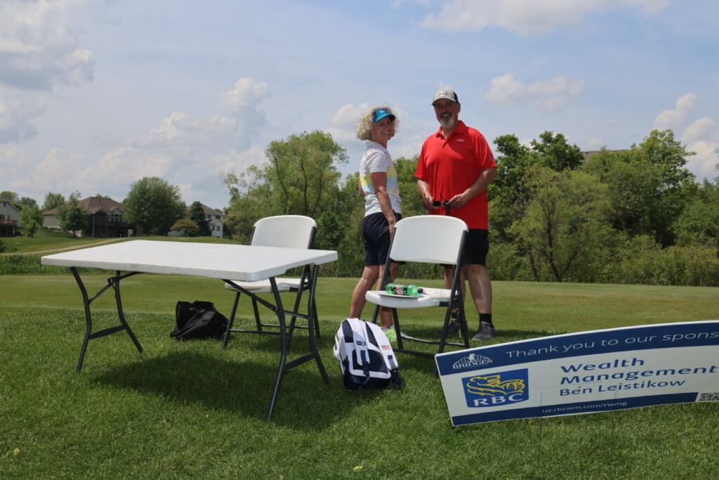Volunteers set up a game at a RBC Wealth Management sponsored hole 4th Annual Bridges to Learning Golf Tournament at The Wilds Golf Club, Prior Lake Minnesota. Raising funds to educate and care for poor children in Vietnam.