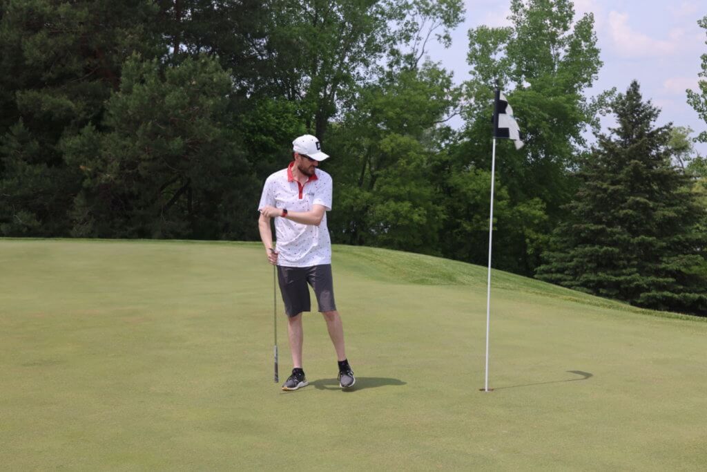 Golfer sizes up the putt at the Wilds Golf Club course at the 4th Annual Bridges to Learning Golf Tournament, Prior Lake Minnesota. Raising funds to educate and care for poor children in Vietnam.