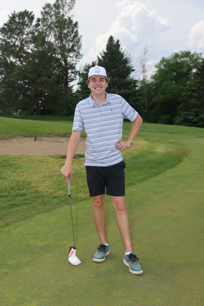 Golfer poses for a photo on the Wilds Golf Club course at the 4th Annual Bridges to Learning Golf Tournament, Prior Lake Minnesota. Raising funds to educate and care for poor children in Vietnam.