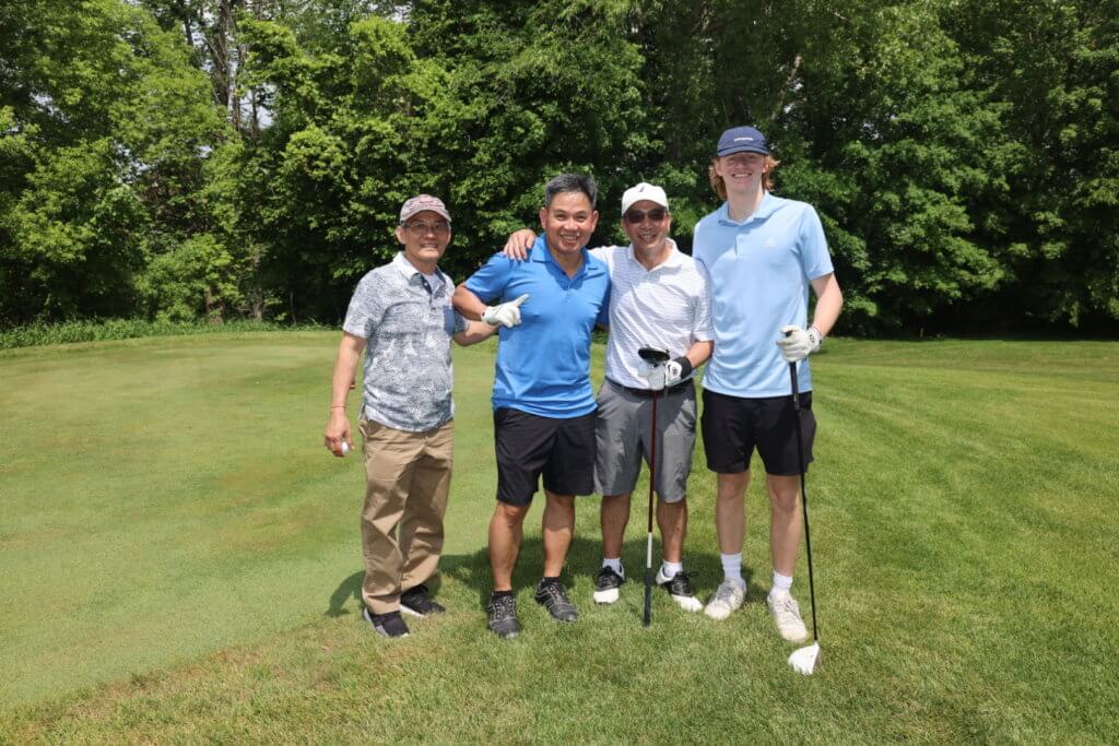 Four golfers pose for a photo on the Wilds Golf Club course at the 4th Annual Bridges to Learning Golf Tournament, Prior Lake Minnesota. Raising funds to educate and care for poor children in Vietnam.