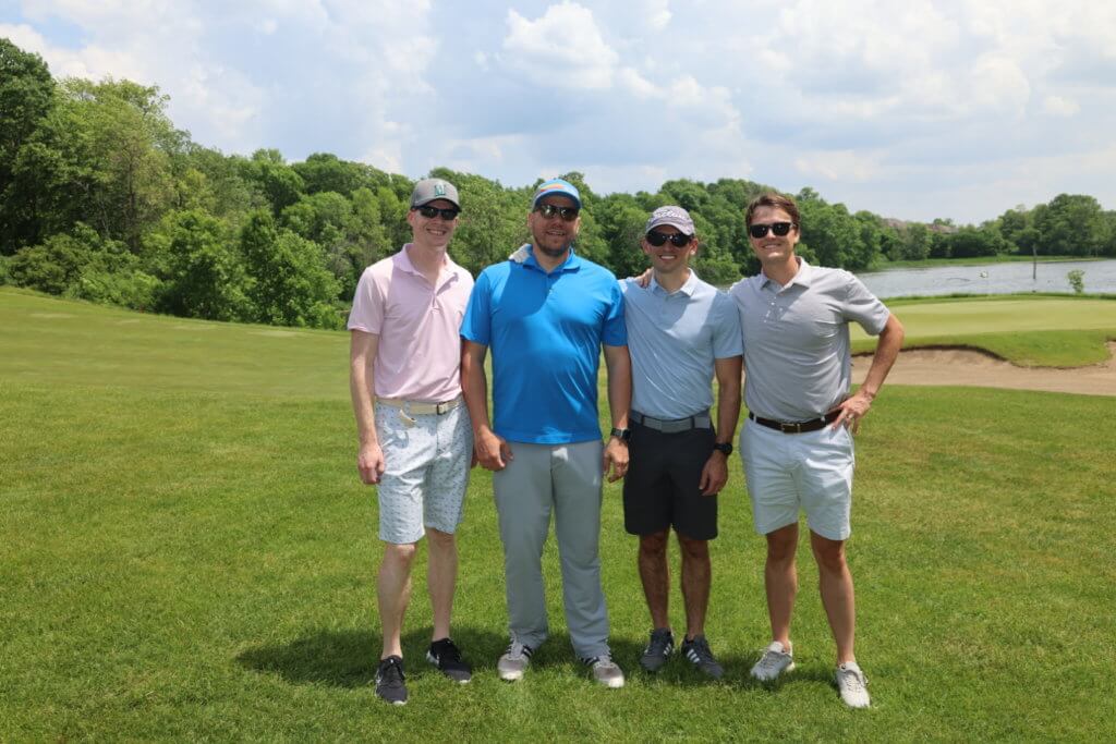 Four golfers pose for a photo on the Wilds Golf Club course at the 4th Annual Bridges to Learning Golf Tournament, Prior Lake Minnesota. Raising funds to educate and care for poor children in Vietnam.