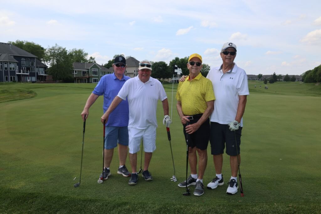 Four golfers pose for a photo on the Wilds Golf Club course at the 4th Annual Bridges to Learning Golf Tournament, Prior Lake Minnesota. Raising funds to educate and care for poor children in Vietnam.