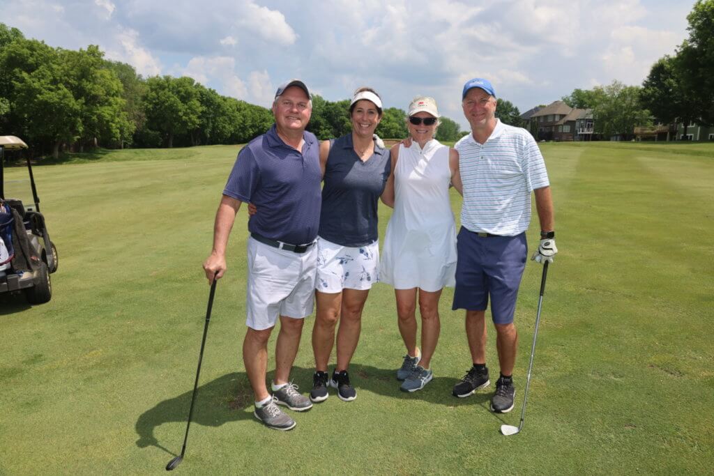 Four golfers pose for a photo on the Wilds Golf Club course at the 4th Annual Bridges to Learning Golf Tournament, Prior Lake Minnesota. Raising funds to educate and care for poor children in Vietnam.