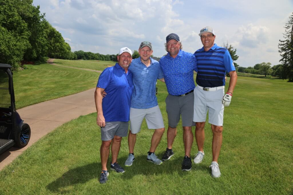 Four golfers pose for a photo on the Wilds Golf Club course at the 4th Annual Bridges to Learning Golf Tournament, Prior Lake Minnesota. Raising funds to educate and care for impoverished children in Vietnam.