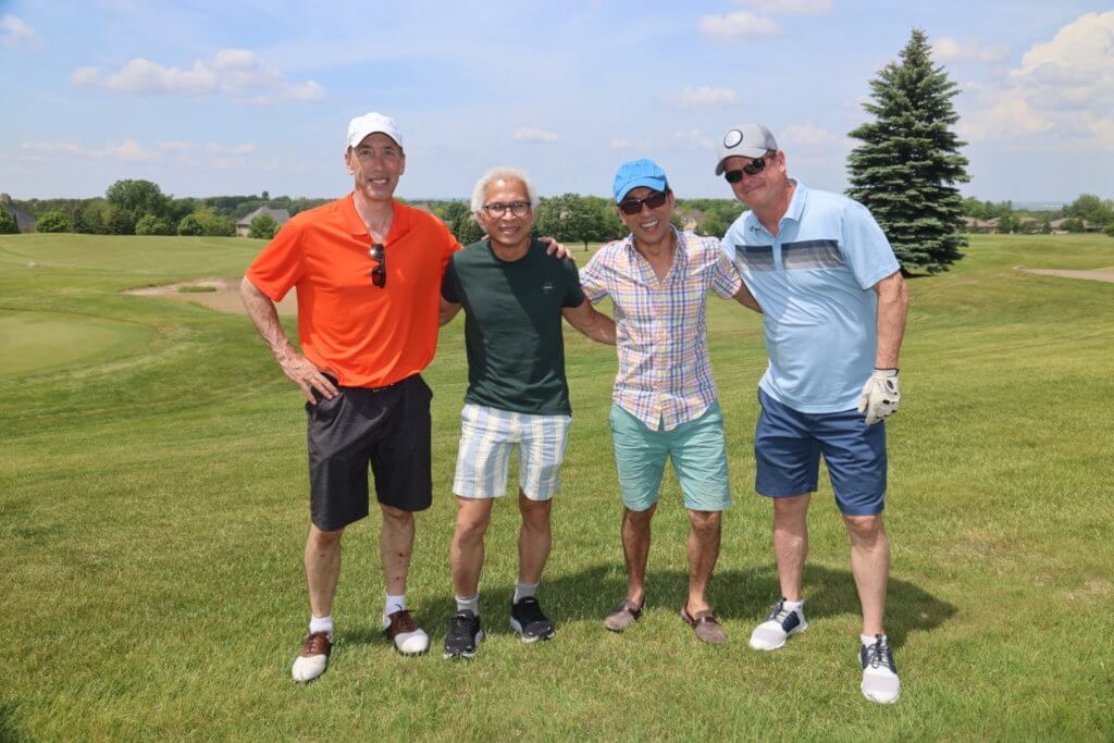 Four golfers pose for a photo on the Wilds Golf Club course at the 4th Annual Bridges to Learning Golf Tournament, Prior Lake Minnesota. Raising funds to educate and care for impoverished children in Vietnam.