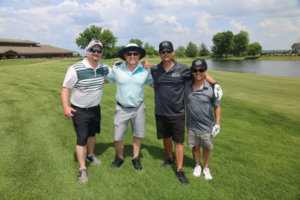 Four golfers pose for a photo on the Wilds Golf Club course at the 4th Annual Bridges to Learning Golf Tournament, Prior Lake Minnesota. Raising funds to educate and care for impoverished children in Vietnam.