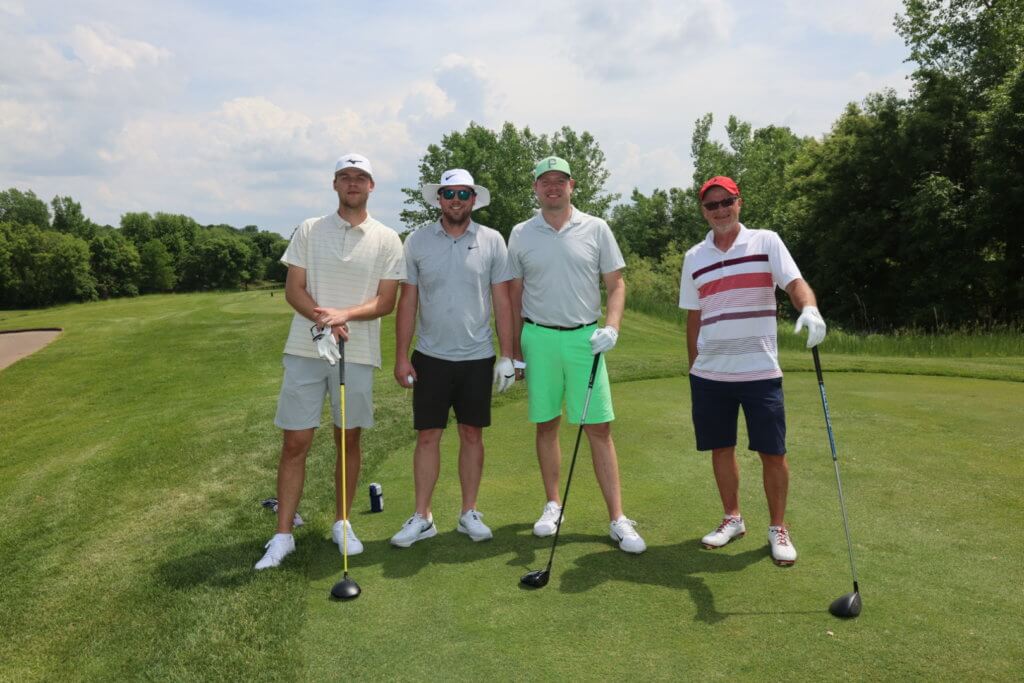 Four golfers pose for a photo on the Wilds Golf Club course at the 4th Annual Bridges to Learning Golf Tournament, Prior Lake Minnesota. Raising funds to educate and care for impoverished children in Vietnam.
