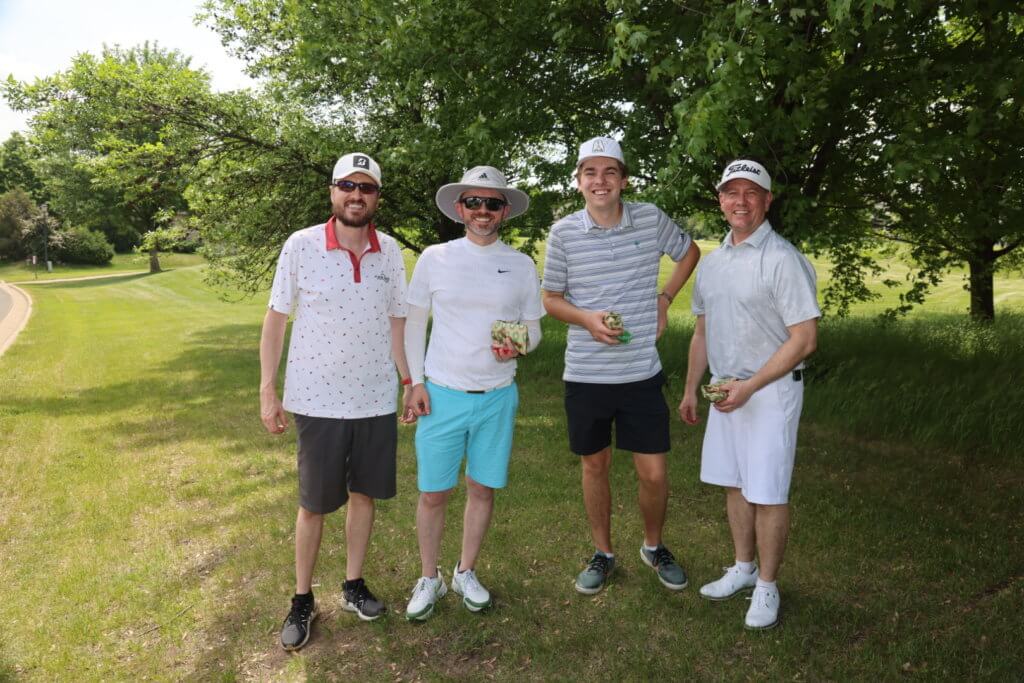 Four golfers pose for a photo on the Wilds Golf Club course at the 4th Annual Bridges to Learning Golf Tournament, Prior Lake Minnesota. Raising funds to educate and care for impoverished children in Vietnam.