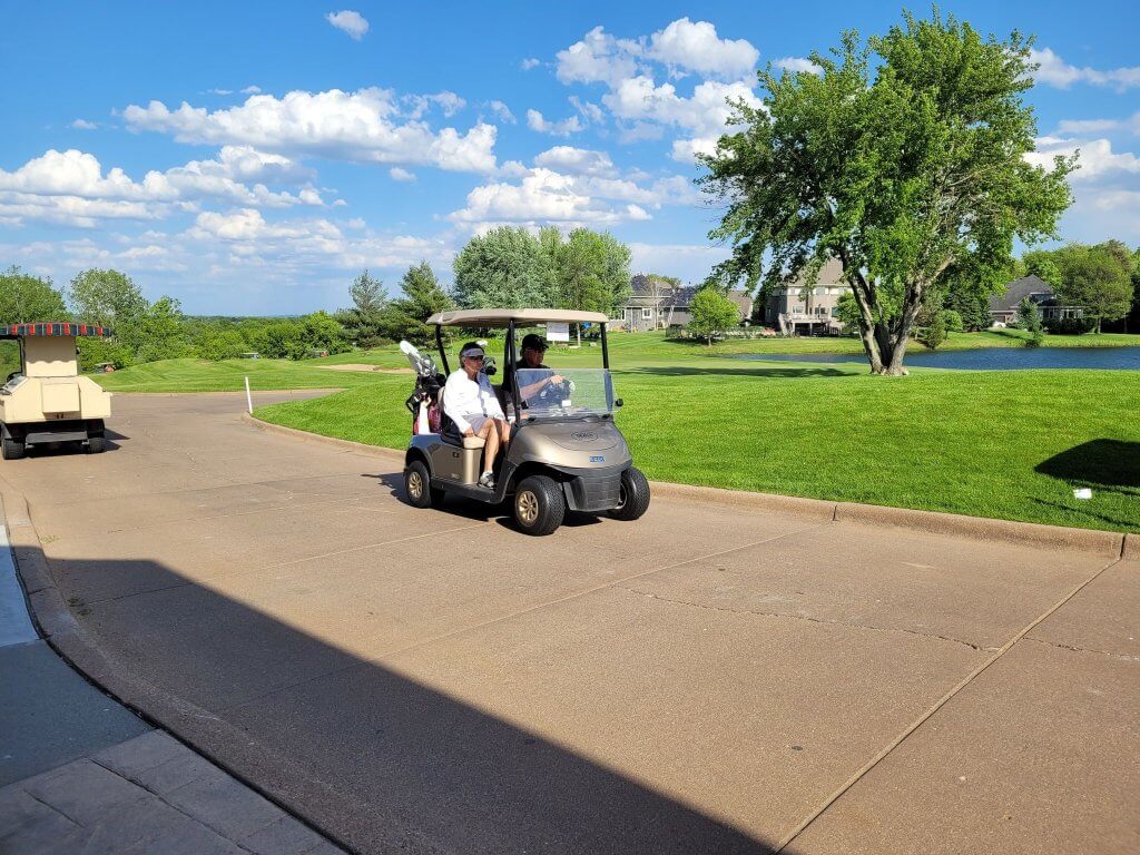 Bridges to Learning 3rd Annual Charity Tournament at The Wilds Golf Club, Prior Lake Minnesota. Happy golfers driving their golf cart out to the course to start the golf scramble.