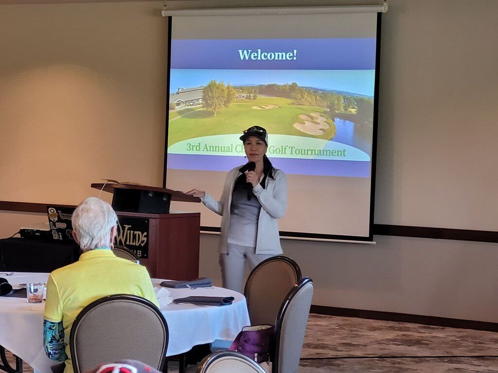 Bridges to Learning 3rd Annual Charity Tournament at The Wilds Golf Club, Prior Lake Minnesota. Linh Phan addressing the golfers in the clubhouse.