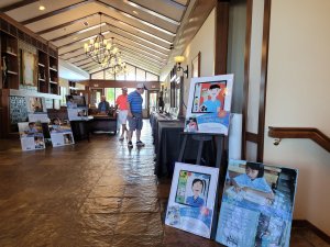 Posters about the impoverished children that are helped by Bridges to Learning greet golfers at the 3rd Annual Golf Tournament at the Wilds Golf Course.