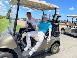 Golfers relaxing in golf cart before heading out to play in the 2022 Bridges to Learning Golf Tournament in Prior Lake Minnesota. 2022.