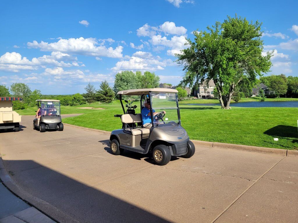 Bridges to Learning 3rd Annual Charity Tournament at The Wilds Golf Club, Prior Lake Minnesota. Happy golfers driving their golf cart out to the course to start the golf scramble.