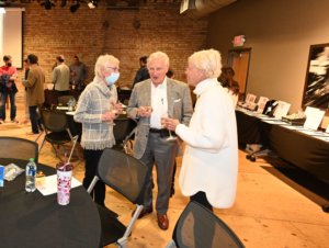 Bridges to Learning founder visits with guests at 2022 Wine Tasting. Raising funds to educate impoverished children in Vietnam.