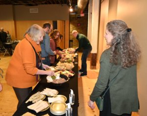 Guests get food from the charcuterie buffet at the 2022 Wine Tasting. Bridges to Learning nonprofit raising funds to educate impoverished children in Vietnam.