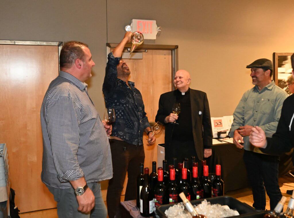 2022 Wine Tasting guests enjoy the porron as they raise funds to educate poor children in Vietnam.