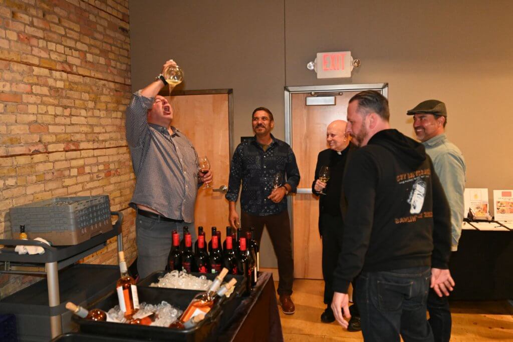 2022 Wine Tasting guests enjoy the porron as they raise funds to educate poor children in Vietnam.