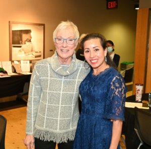 Bridges to Learning founder poses with volunteer. Smiling at 2022 Wine Tasting fundraiser, nonprofit.