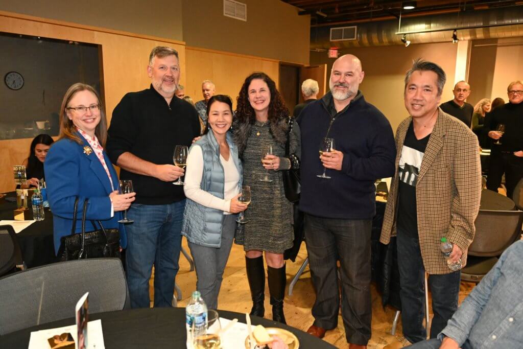 Guests at 2022 Bridges to Learning Wine Tasting pose for a photo. Raising money to educate poor children in Vietnam. Nonprofit.