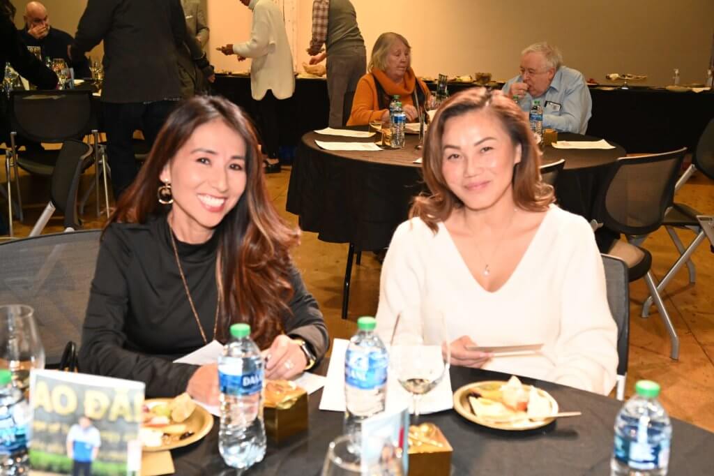 Two women smile as they enjoy the 2022 Wine Tasting. Bridges to Learning nonprofit raising funds to educate poor children in Vietnam.