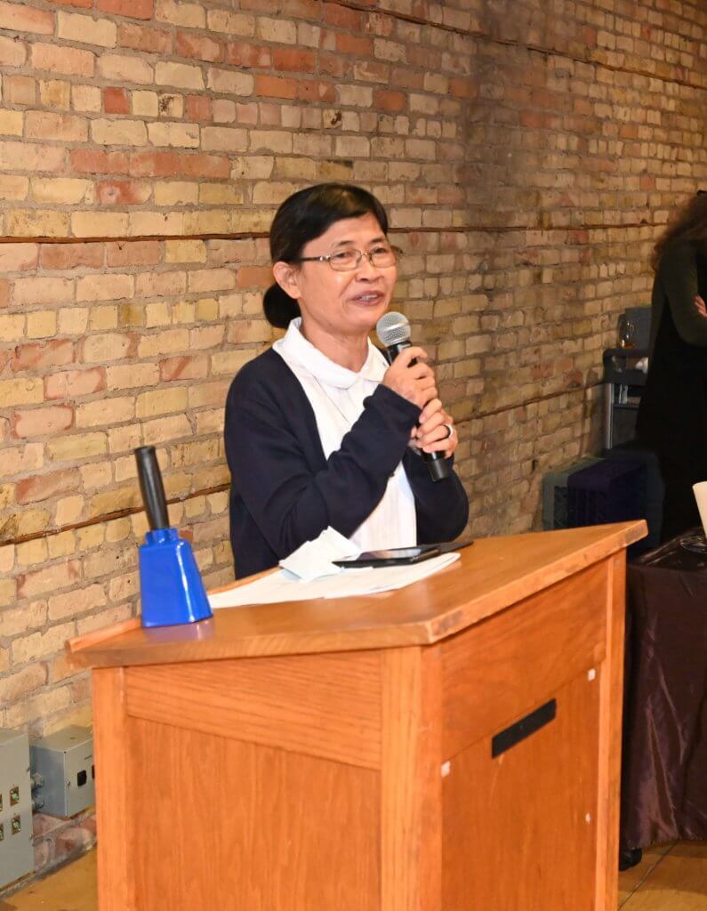 Former principal of school in Vietnam for impoverished children speaks to the guests at the 2022 Bridges to Learning Wine Tasting. Nonprofit.