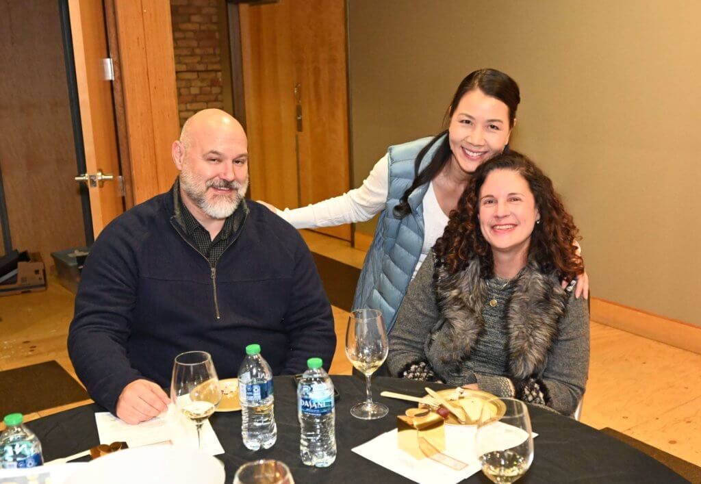 Bridges to Learning board member poses for a photo with two 2022 Wine Tasting guests. Nonprofit raising money to educate poor children in Vietnam.