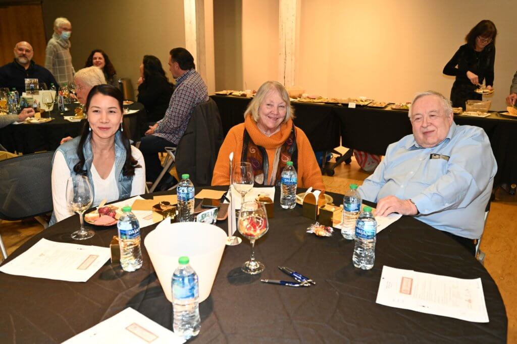Bridges to Learning board member poses for a photo with long time supporters at 2022 Wine Tasting.