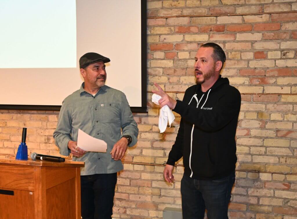Rootstock Wine Co. owner and Cry Baby Craigs Hot Sauce co-owner entertain the guests at the 2022 Wine Tasting for Bridges to Learning. Raising money to help educate poor children in Vietnam for a brighter future.