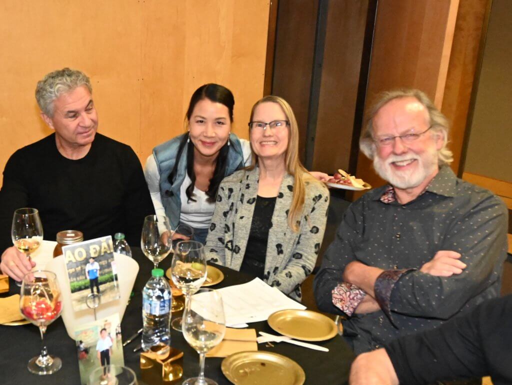Bridges to Learning board member poses for photo with 3 guests at the 2022 Wine Tasting.