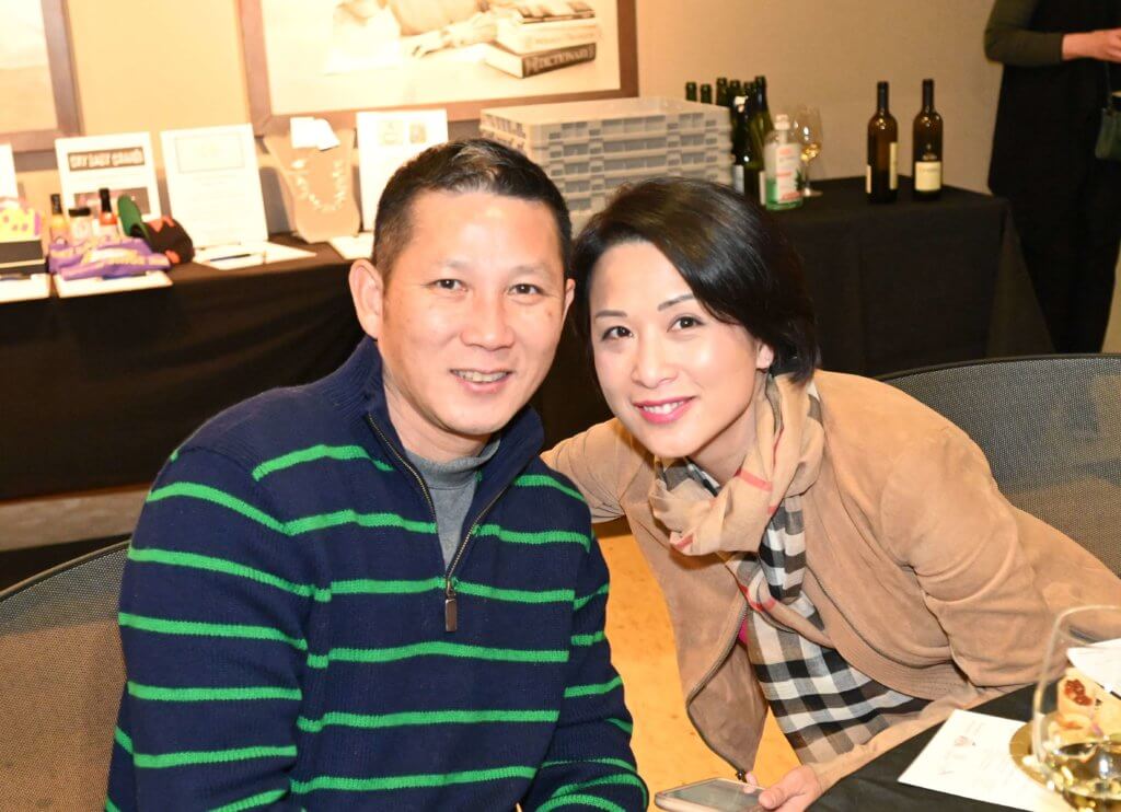 Two smiling 2022 Wine Tasting guests pose for a photo for Bridges to Learning.