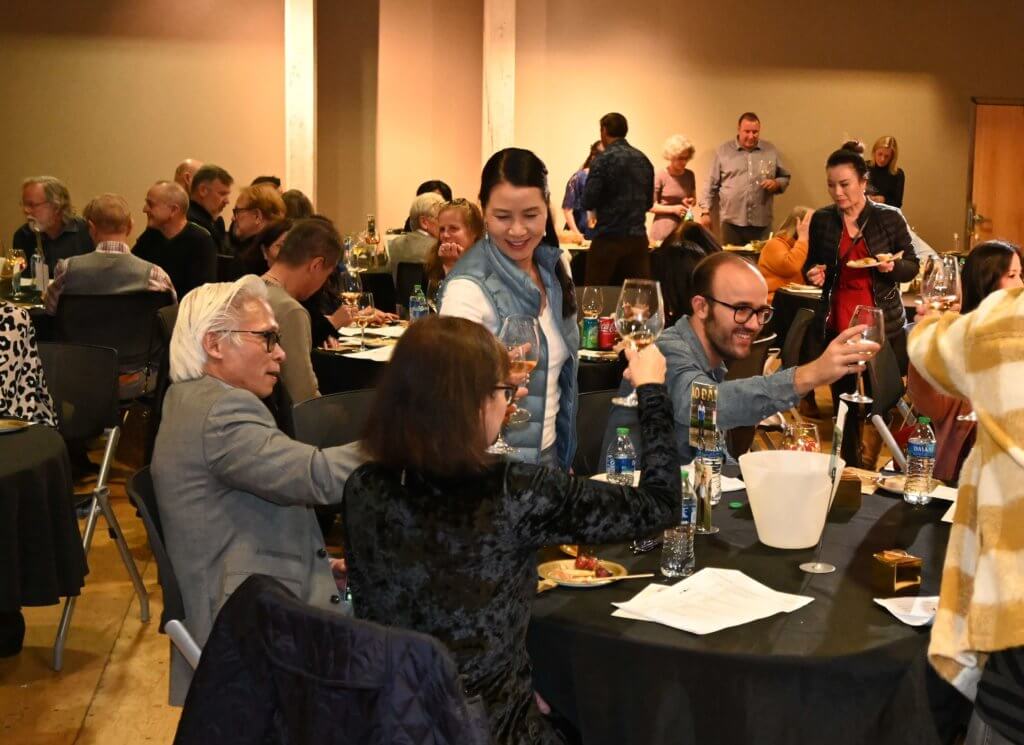 Bridges to Learning board member and supporters raise their glasses and toast the good work done by nonprofit Bridges to Learning. Wine Tasting 2022. Minnesota.