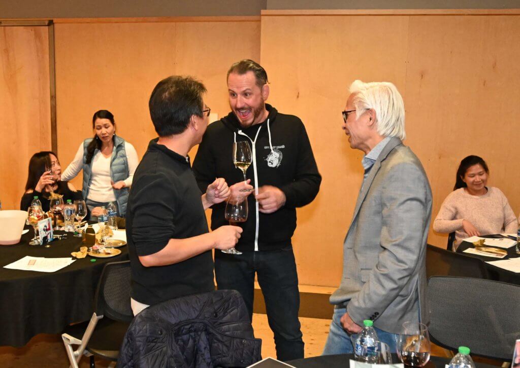 Cry Baby Craig's co-owner visits with guests at the 2022 Wine Tasting. Bridges to Learning nonprofit.