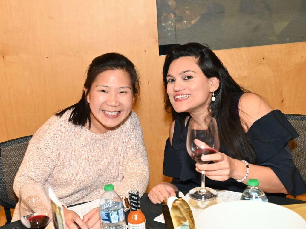 Bridges to Learning board member, and the spouse of another board member, smile and pose for a photo at the 2022 Bridges to Learning Wine Tasting.  Open Book Minneapolis Minnesota.