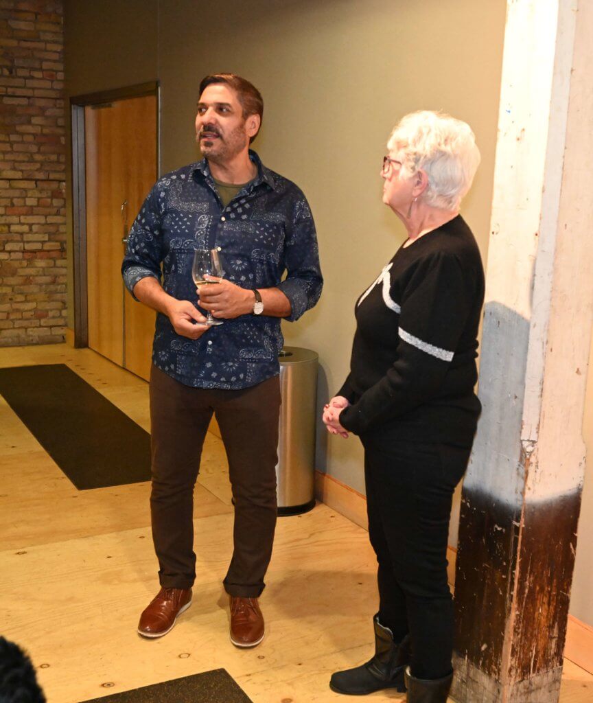 Two guests visit at the Bridges to Learning 2022 Wine Tasting. Nonprofit raising money to provide education for poor children in Vietnam.