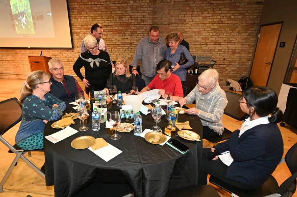 Supporters and volunteers tally up wine orders with South Lyndale LIquors at the Bridges to Learning nonprofit 2022 Wine Tasting fundraiser. Raising money to provide education to poor children in Vietnam.