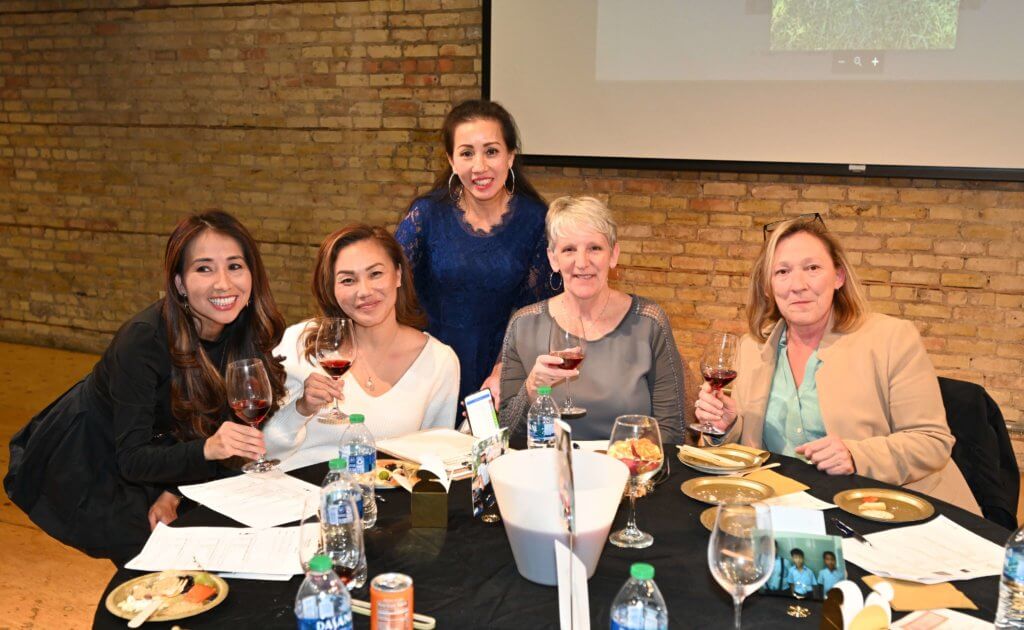 Five 2022 Wine Tasting supporters pose for a photo at the Bridges to Learning nonprofit fundraiser.