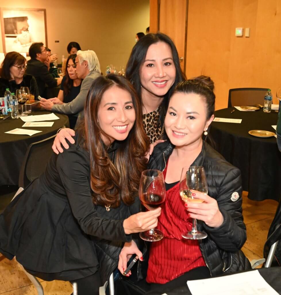 Three 2022 Wine Tasting guests pose for a photo at the Bridges to Learning nonprofit fundraiser.