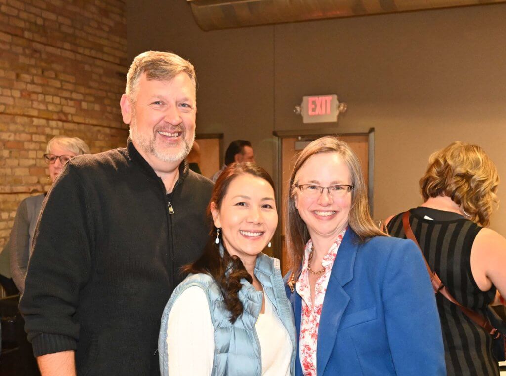 Bridges to Learning board member poses with two guests at the 2022 Wine Tasting event. Raising funds to provide education to poor children in Vietnam.