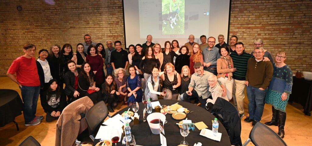 Big group photo of Bridges to Learning supporters and volunteers at the 2022 Wine Tasting charity fundraiser. Open Book Minneapolis Minnesota. Rootstock Wine Company. South Lyndale Liquors.