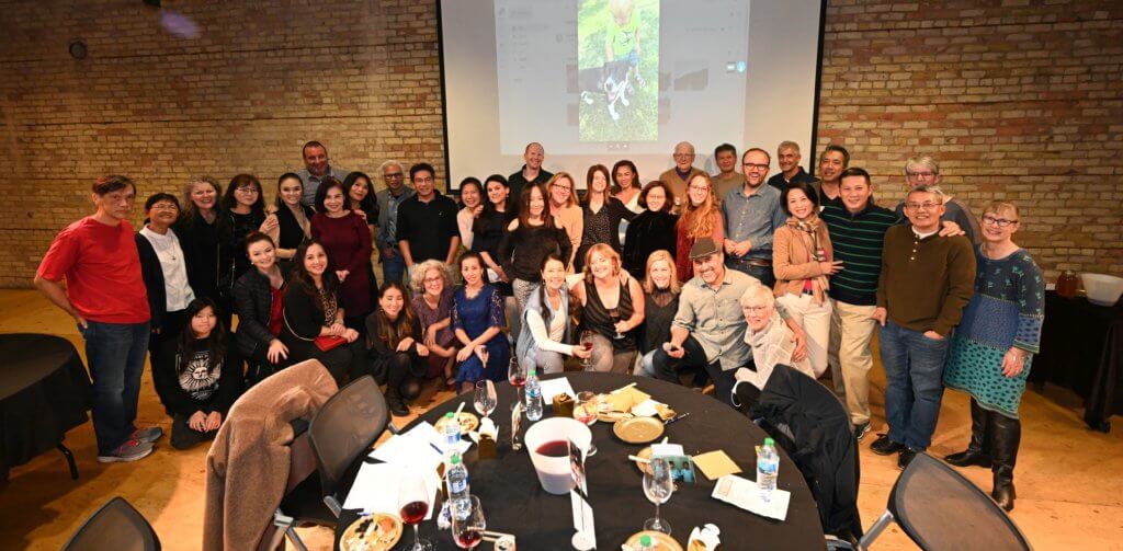 Big group photo of Bridges to Learning supporters and volunteers at the 2022 Wine Tasting charity fundraiser. Open Book Minneapolis Minnesota. Rootstock Wine Company. South Lyndale Liquors.