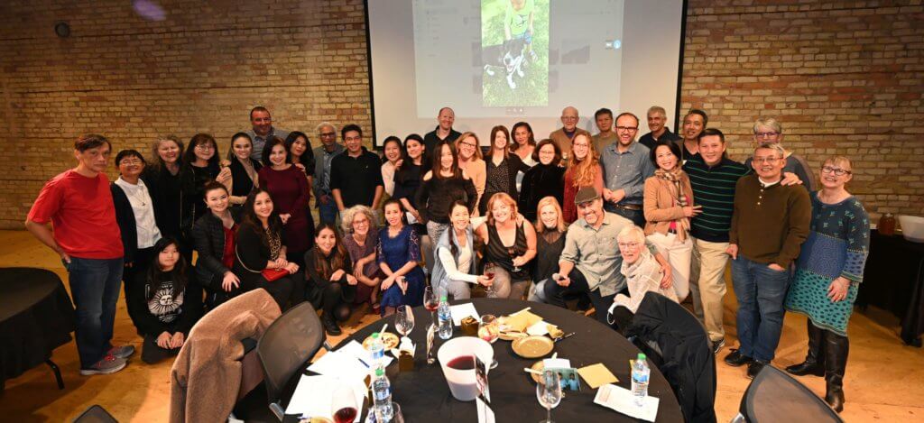 Big group photo of Bridges to Learning supporters and volunteers at the 2022 Wine Tasting charity fundraiser. Open Book Minneapolis Minnesota. Rootstock Wine Company. South Lyndale Liquors.
