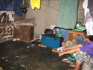 Poor sitting child at home Anh Linh School Saigon HCMC Vietnam