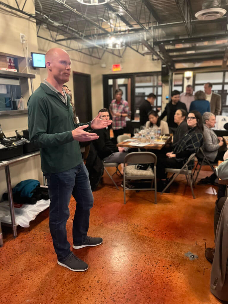Bridges to Learning Board Chair, Joe Hellman, welcoming guests at the 2023 Wine Tasting fundraiser. Supporting the education of impoverished children in Vietnam.