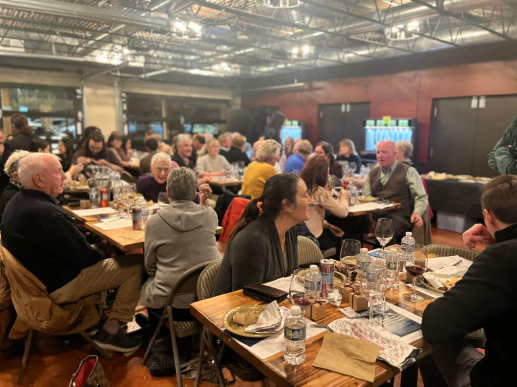 Guests at Bridges to Learning 2023 Wine Tasting sitting at tables. Supporting the education of impoverished children in Vietnam.