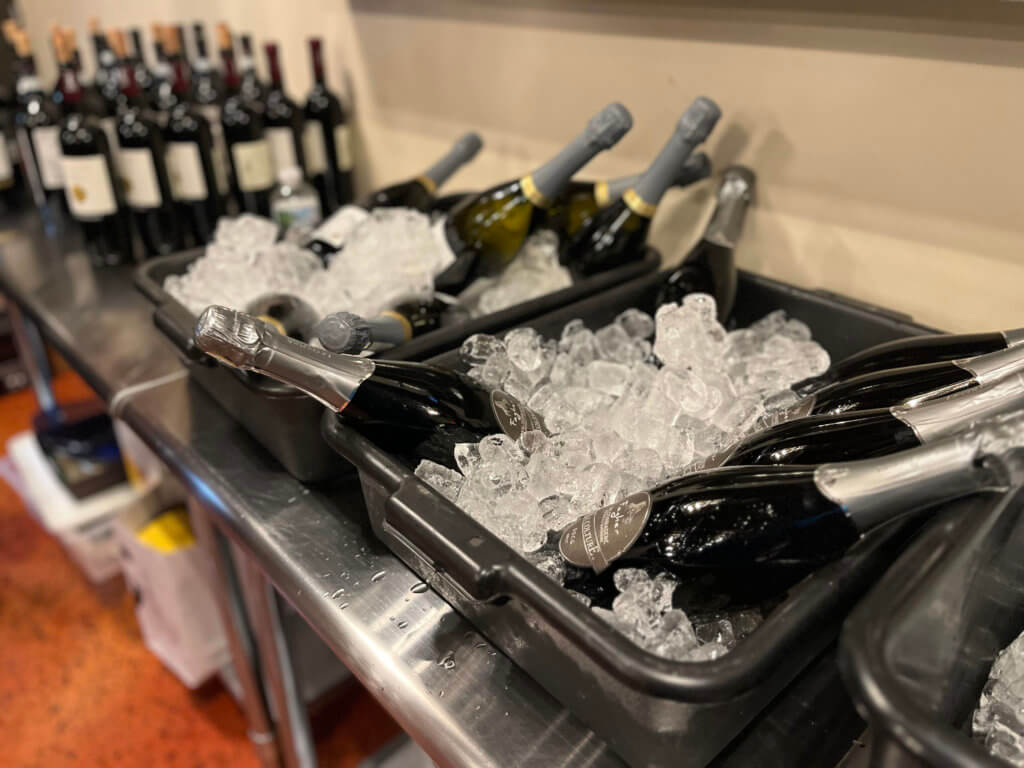Prosecco and Moscato chilling in tubs for the 2023 Bridges to Learning Wine Tasting fundraiser. Nonprofit raising funds to educate and nourish poor children in Vietnam. South Lyndale Liquors event space.